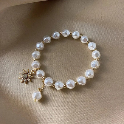 Pulsera con colgante en oro blanco, perla y girasol